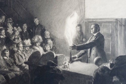 A Man in a frock coat holding his hand near a flame