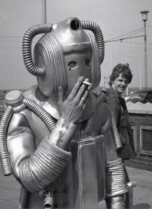 A cyberman from Doctor Who having a cigarette break