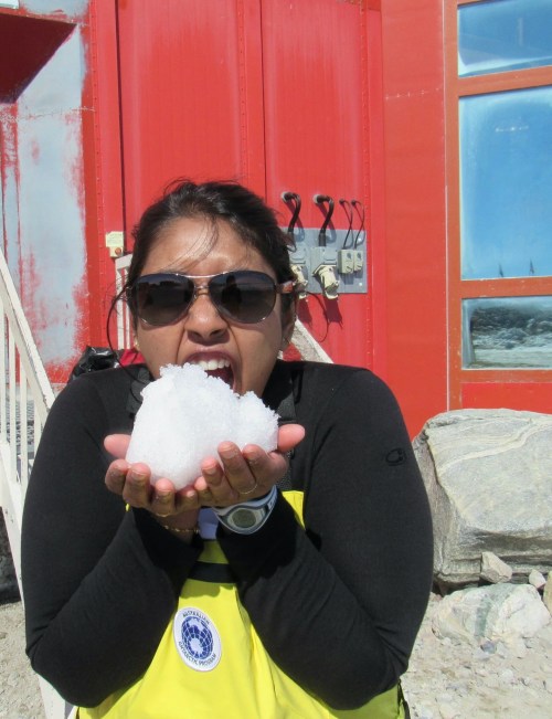 A woman in sunglasses holding snow
