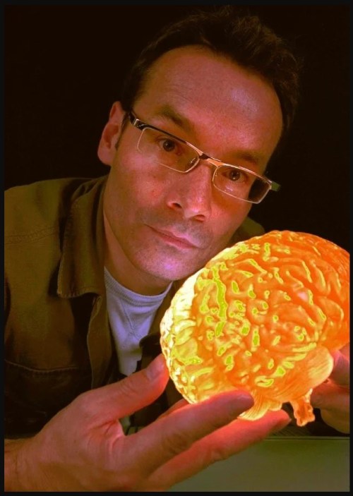 A Man holding a glowing brain